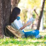 woman reading a most popular language book under a tree