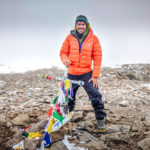 Peter on the summit of Aconcagua in an orange down jacket