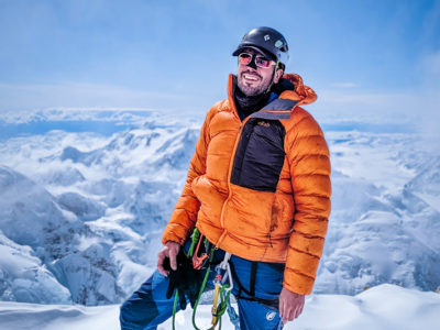 Peter on Denali in a down jacket and climbing ropes