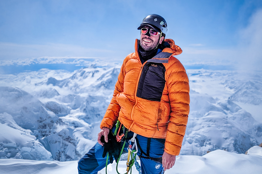 Peter on Denali in a down jacket and climbing ropes