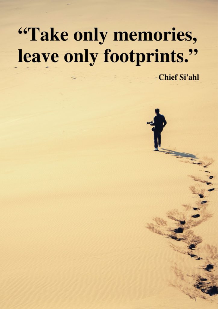 A man walking in the sand featuring the travel quote about footprints