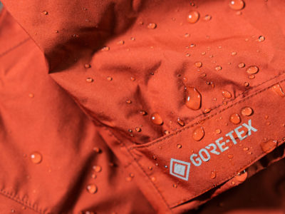 A close up of water droplets on a red Gore-tex waterproof jacket