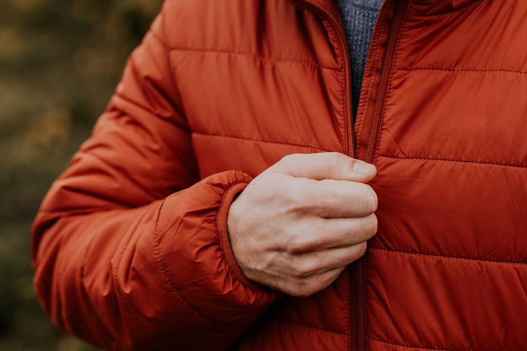 never break a zipper again as a man zips his red down jacket closed