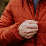 never break a zipper again as a man zips his red down jacket closed