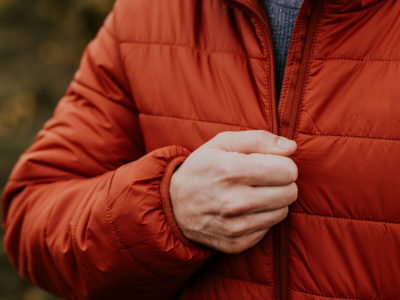 never break a zipper again as a man zips his red down jacket closed