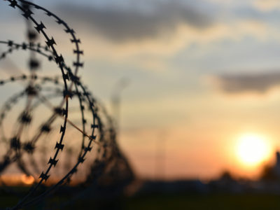 a line of barbed wire at sunset