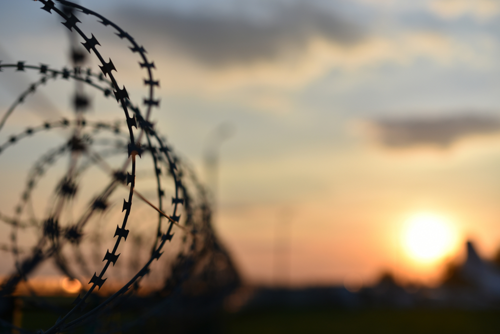 a line of barbed wire at sunset